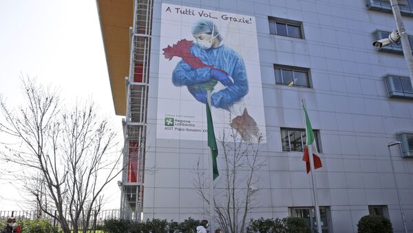 A giant image of a drawing by Venetian artist Franco Rivolli showing a doctor with wings on her back cradling Italy and writing in Italian reading To all of you... Thank you!, is displayed on the facade of Bergamo's Papa Giovanni XXIII hospital, in Bergamo, northern Italy, Monday, March 16, 2020 - Sputnik International