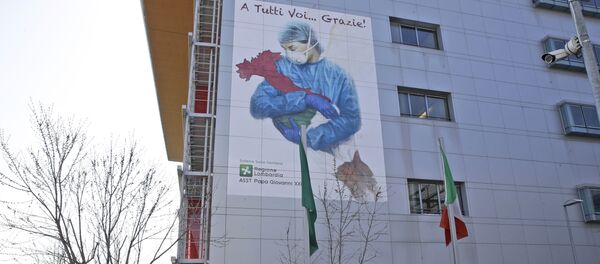A giant image of a drawing by Venetian artist Franco Rivolli showing a doctor with wings on her back cradling Italy and writing in Italian reading To all of you... Thank you!, is displayed on the facade of Bergamo's Papa Giovanni XXIII hospital, in Bergamo, northern Italy, Monday, March 16, 2020 - Sputnik International