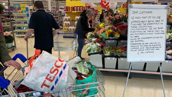 A customer walks past a sign informing shoppers about limited stock inside a Tesco supermarket, during the coronavirus disease (COVID-19) outbreak, in Liverpool, Britain, March 18, 2020.  - Sputnik International