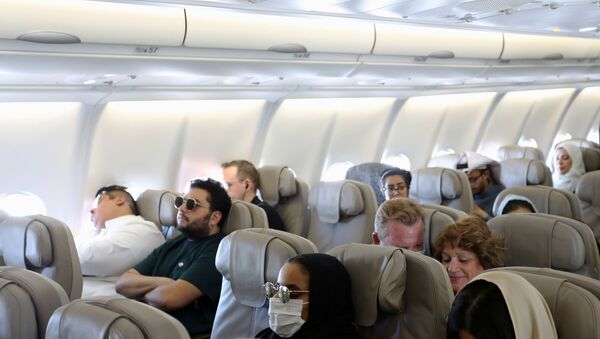 Passengers wear protective face masks following an outbreak of coronavirus, on a plane of Saudi Airlines, during their trip to al-Ula to attend the Tantura Festival, Saudi Arabia March 6, 2020 - Sputnik International