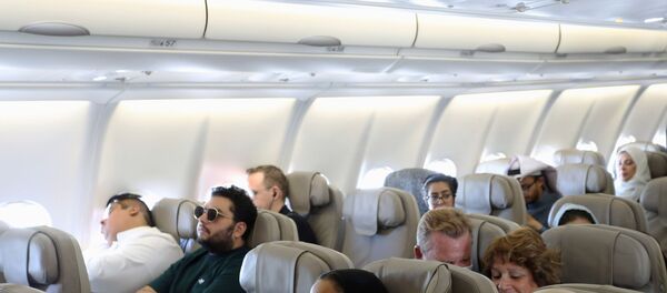 Passengers wear protective face masks following an outbreak of coronavirus, on a plane of Saudi Airlines, during their trip to al-Ula to attend the Tantura Festival, Saudi Arabia March 6, 2020 - Sputnik International