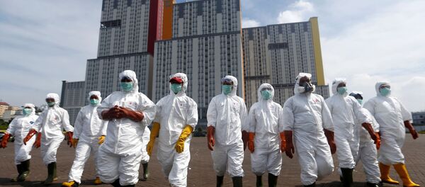 Indonesian Red Cross Society personnel walk in protective suits during an operation to spray disinfectant at the Kemayoran Athletes Village, to prevent the spread of coronavirus disease (COVID-19) in Jakarta, Indonesia, March 21, 2020. Indonesian Red Cross Society personnel walk in protective suits during an operation to spray disinfectant at the Kemayoran Athletes Village, to prevent the spread of coronavirus disease (COVID-19) in Jakarta, Indonesia, March 21, 2020. - Sputnik International