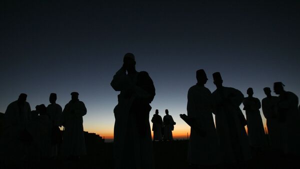 Members of the ancient Samaritan community walk to the religion's holiest site on top of Mount Gerizim near the West Bank town of Nablus, for their annual  pilgrimage for the holiday of Tabernacles or Sukkot early Monday, Oct. 13, 2008. Named for Samaria, a region in the northern West Bank, the Samaritans believe themselves to be the remnants of Israelites exiled by the Assyrians in 722 B.C. They practice a religion closely linked to Judaism and venerate a version of the Old Testament, but are not Jews. (AP Photo/Bernat Armangue) - Sputnik International