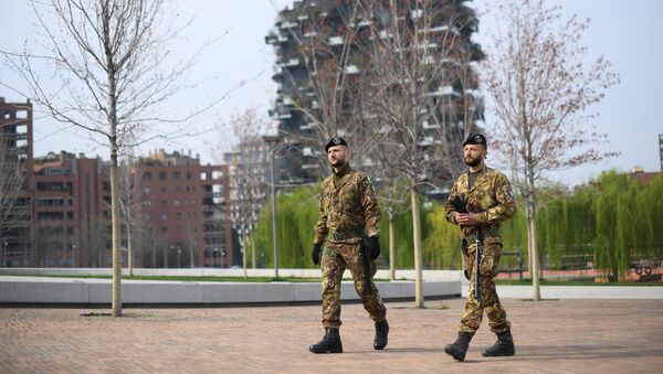 Italian army soldiers patrol streets after being deployed to the region of Lombardy to enforce the lockdown against the spread of coronavirus disease (COVID-19) in Milan, Italy, March 20, 2020 - Sputnik International