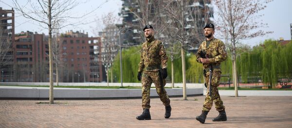 Italian army soldiers patrol streets after being deployed to the region of Lombardy to enforce the lockdown against the spread of coronavirus disease (COVID-19) in Milan, Italy, March 20, 2020 - Sputnik International