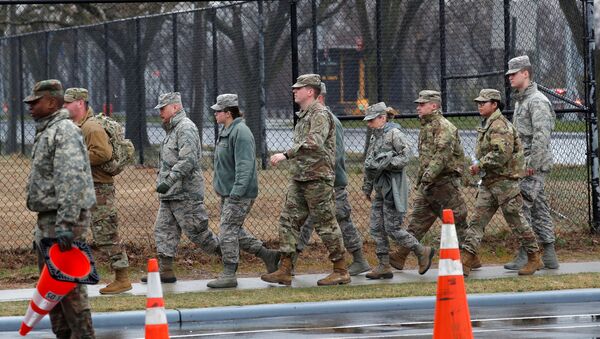 U.S. military personnel walk outside a new coronavirus testing center in the Staten Island borough of New York City, New York, U.S., March 19, 2020 - Sputnik International