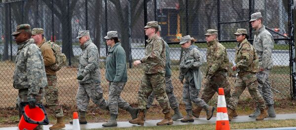 U.S. military personnel walk outside a new coronavirus testing center in the Staten Island borough of New York City, New York, U.S., March 19, 2020 - Sputnik International