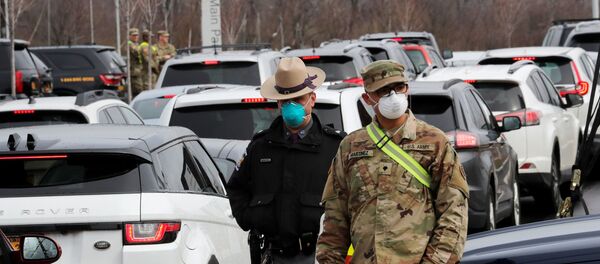 Police and U.S. Military personnel work amid a line of cars of people arriving for testing at a new drive-thru coronavirus disease (COVID-19) testing center in the Staten Island borough of New York City, New York, U.S., March 19, 2020 Police and U.S. Military personnel work amid a line of cars of people arriving for testing at a new drive-thru coronavirus disease (COVID-19) testing center in the Staten Island borough of New York City, New York, U.S., March 19, 2020 - Sputnik International