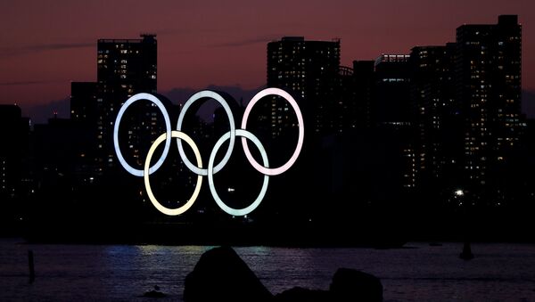 The giant Olympic rings are seen in the dusk at the waterfront area at Odaiba Marine Park in Tokyo - Sputnik International