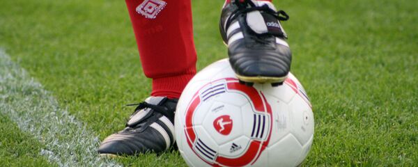 Foot of a soccer player in a football boot on a ball  - Sputnik International
