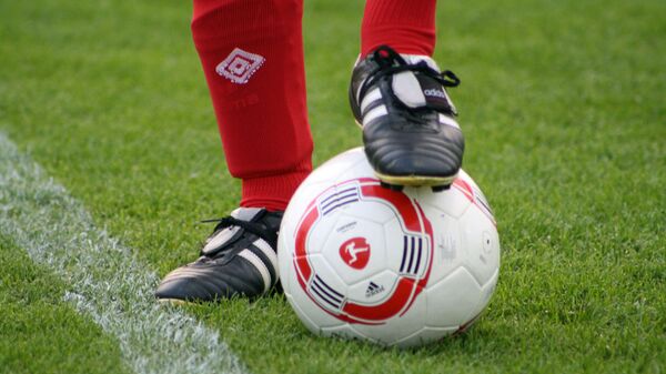 Foot of a soccer player in a football boot on a ball  - Sputnik International