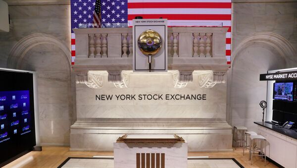 The bell used to open and close the markets hangs in front of an empty podium above the floor of the New York Stock Exchange (NYSE) as it prepares to close due to the coronavirus disease (COVID-19) outbreak in New York, U.S., 20 March, 2020 - Sputnik International