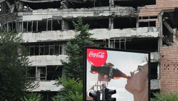 Coca Cola billboard in front of a building in Belgrade damaged during the 1999 NATO airstrikes. - Sputnik International