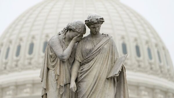 Grief holds her covered face against the shoulder of History and weeps in mourning as depicted at the Peace Monument in front of the U.S. Capitol in Washington, U.S., March 23, 2020.  The U.S. Senate struggled to reach agreement on a far-reaching coronavirus stimulus package on Monday. - Sputnik International