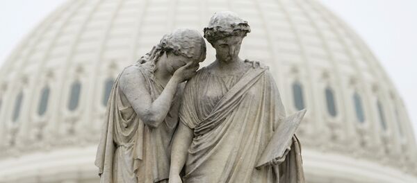 Grief holds her covered face against the shoulder of History and weeps in mourning as depicted at the Peace Monument in front of the U.S. Capitol in Washington, U.S., March 23, 2020.  The U.S. Senate struggled to reach agreement on a far-reaching coronavirus stimulus package on Monday. - Sputnik International