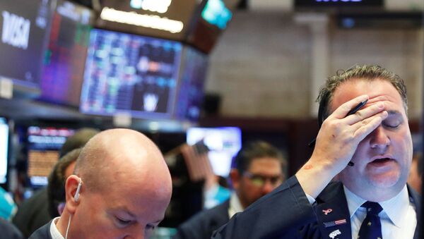 A trader reacts as he works on the floor of the New York Stock Exchange as markets continue to react to the coronavirus disease (COVID-19) at the NYSE in New York, U.S., 18 March 2020.   - Sputnik International