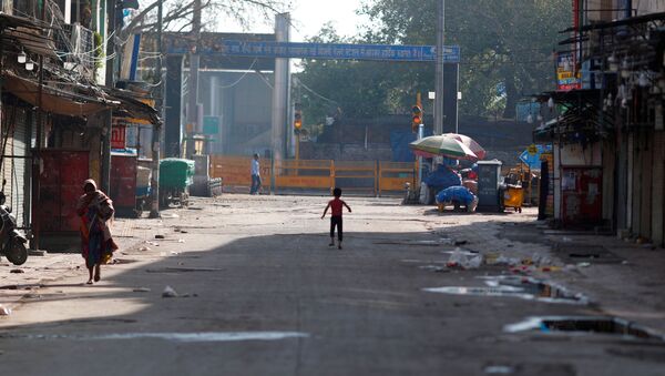 A boy plays on a near-empty street during a lockdown amid a coronavirus disease (COVID-19) outbreak in New Delhi, India, March 25, 2020 - Sputnik International