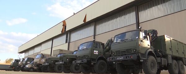 In this handout photo released by the Russian Defence Ministry, trucks with medical equipment for transfer to Coronavirus-Hit Italy are pictured at the Pratica di Mare military base, Italy - Sputnik International