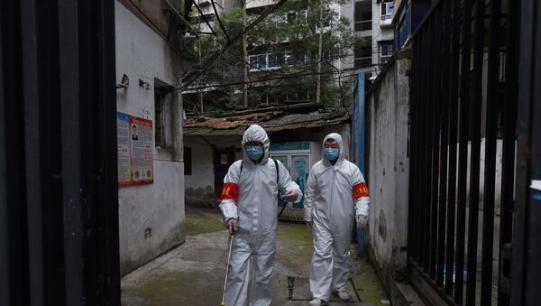 Community workers in protective suits disinfect a residential compound in Wuhan, the epicentre of the novel coronavirus outbreak, Hubei province, China March 6, 2020. - Sputnik International
