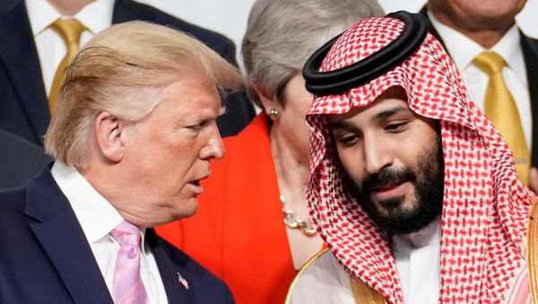 U.S. President Donald Trump speaks with Saudi Arabia's Crown Prince Mohammed bin Salman during family photo session with other leaders and attendees at the G20 leaders summit in Osaka, Japan, June 28, 2019.   - Sputnik International