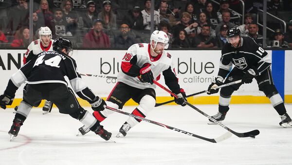Mar 11, 2020; Los Angeles, California, USA; Ottawa Senators left wing Mikkel Boedker (89) handles the puck under pressure from Los Angeles Kings defenseman Mikey Anderson (44) and center Michael Amadio (10)  in the third period at Staples Center. The Kings won 3-2.  - Sputnik International