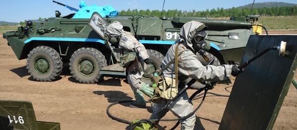 Members of a radiation, chemical and biological reconnaissance team use reagents to disinfect the surface of a dangerous area during the military-district stage of the Safe Environment 2016 army contest involving radiation, chemical and biological reconnaissance teams in the Trans-Baikal Territory - Sputnik International