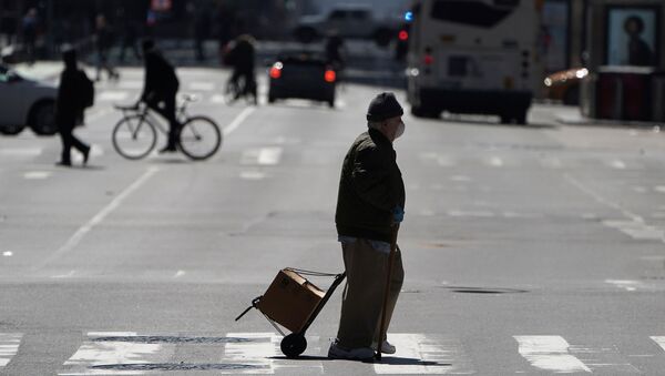 A pedestrian crosses a deserted 7th Ave in Times Square during the outbreak of Coronavirus disease (COVID-19), in the Manhattan borough of New York City, New York, U.S., March 26, 2020.  - Sputnik International