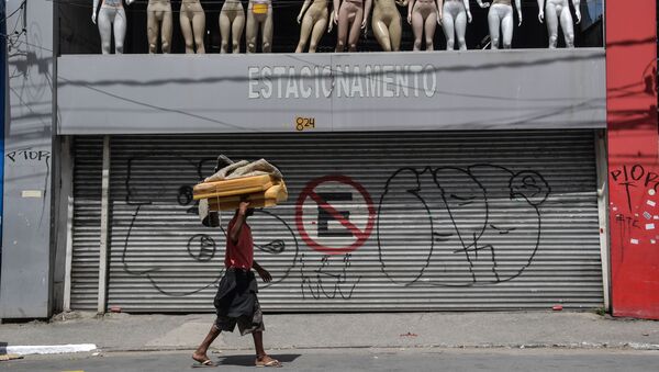 A homeless walks past a closed parking lot and mannequins in downtown Sao Paulo, Brazil - Sputnik International
