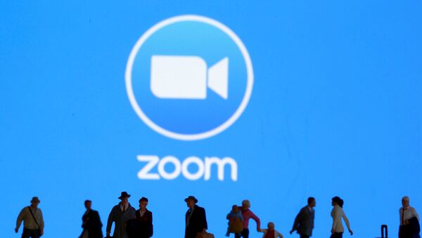 Small toy figures are seen in front of displayed Zoom logo in this illustration taken March 19, 2020.  - Sputnik International