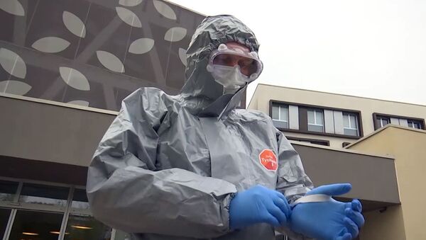 A Russian military expert in a protection suit near hospital facilities for elderly people to fight against the COVID-19 coronavirus infection, in Bergamo, Italy - Sputnik International