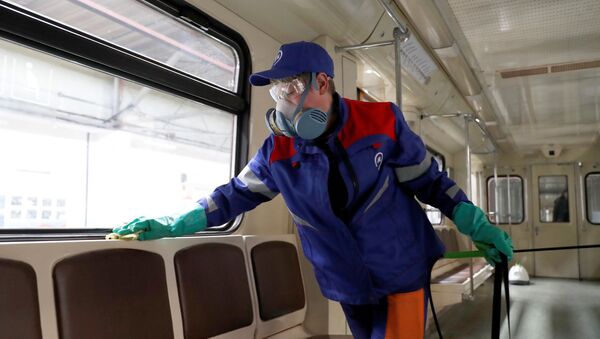 A worker cleans and disinfects a metro train as the spread of the coronavirus disease (COVID-19) continues, in Moscow, Russia March 25, 2020. - Sputnik International