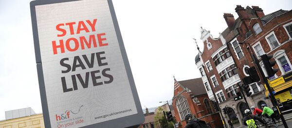 Cyclists pass an electronic billboard displaying a Public health information campaign message from the UK government and local government in London as the spread of the coronavirus disease (COVID-19) continues, London, Britain, March 28, 2020. Cyclists pass an electronic billboard displaying a Public health information campaign message from the UK government and local government in London as the spread of the coronavirus disease (COVID-19) continues, London, Britain, March 28, 2020. - Sputnik International