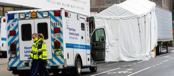 Paramedics walk next to a makeshift morgue set outside Lenox Health Medical Pavilion as the coronavirus disease (COVID-19) outbreak continues in New York, US, March 29, 2020 - Sputnik International