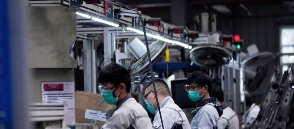 Employees wearing face masks work on a car seat assembly line at Yanfeng Adient factory in Shanghai, China, as the country is hit by an outbreak of a new coronavirus, February 24, 2020 - Sputnik International