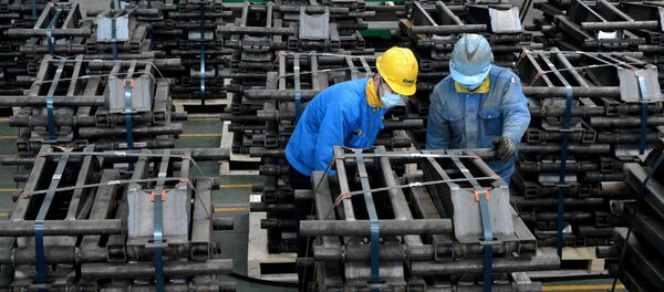 Workers wearing face masks are seen on a production line manufacturing parts for trailers to be exported to the U.S. at a factory, as the country is hit by an outbreak of the novel coronavirus disease (COVID-19), in Taizhou, Jiangsu province, China March 28, 2020. Picture taken March 28, 2020 - Sputnik International