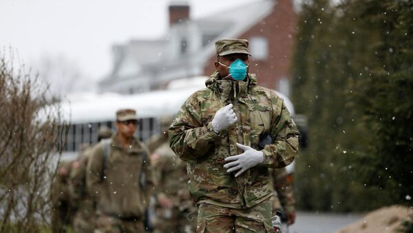Members of Joint Task Force 2, composed of soldiers and airmen from the New York Army and Air National Guard, arrive to sanitize and disinfect the Young Israel of New Rochelle synagogue, as snow falls during the coronavirus disease (COVID-19) outbreak in New Rochelle, New York, U.S., March 23, 2020 - Sputnik International