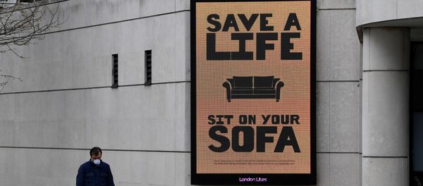 A man walks past a Public Health advertisment in London A man walks past a Public Health advertisment in London - Sputnik International