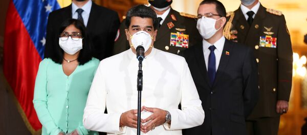 Venezuela's President Nicolas Maduro wearing a protective face mask makes a statement at Miraflores Palace in Caracas, Venezuela March 30, 2020 - Sputnik International