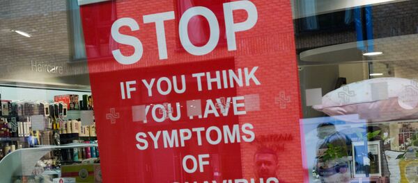 A poster in the window of a pharmacy is pictured in Royal Wharf as the spread of the coronavirus disease (COVID-19) continues, in London, Britain, March 31, 2020 - Sputnik International