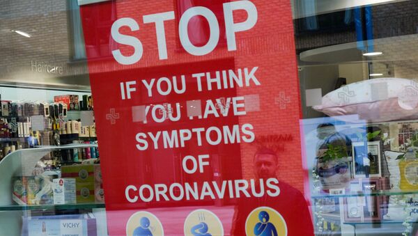 A poster in the window of a pharmacy is pictured in Royal Wharf as the spread of the coronavirus disease (COVID-19) continues, in London, Britain, March 31, 2020 - Sputnik International