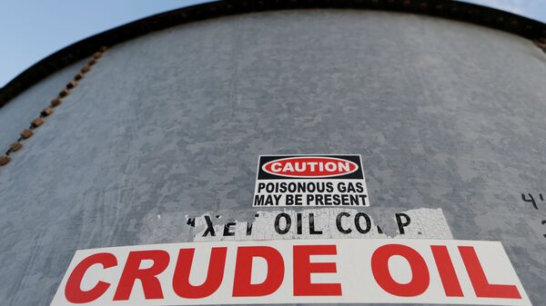 A sticker reads crude oil on the side of a storage tank in the Permian Basin in Mentone, Loving County, Texas, U.S. November 22, 2019. Picture taken November 22, 2019 - Sputnik International