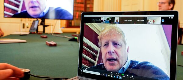 Britain's Prime Minister Boris Johnson appears on monitors for the coronavirus disease (COVID-19) meeting in London, Britain March 28, 2020. The prime minister chairs the morning update meeting on the coronavirus remotely from Number 11 Downing Street, since self-isolating after testing positive for the virus. Britain's Prime Minister Boris Johnson appears on monitors for the coronavirus disease (COVID-19) meeting in London, Britain March 28, 2020. The prime minister chairs the morning update meeting on the coronavirus remotely from Number 11 Downing Street, since self-isolating after testing positive for the virus. - Sputnik International