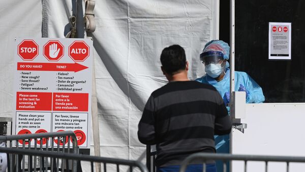 In this file photo taken on March 27, 2020 a medical worker walks out of a coronavirus, COVID-19, testing tent at Brooklyn Hospital Center in New York City. - Sputnik International