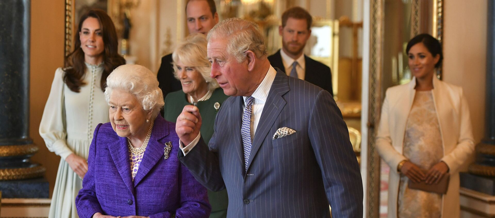 Queen Elizabeth II is joined by Prince Charles, the Prince of Wales, and behind from left, Kate, Duchess of Cambridge, Camilla, Duchess of Cornwall, Prince William, Prince Harry and Meghan, Duchess of Sussex during a reception at Buckingham Palace, London, Tuesday 5 March 2019, to mark the 50th anniversary of the Prince of Wales' investiture. - Sputnik International, 1920, 09.03.2021