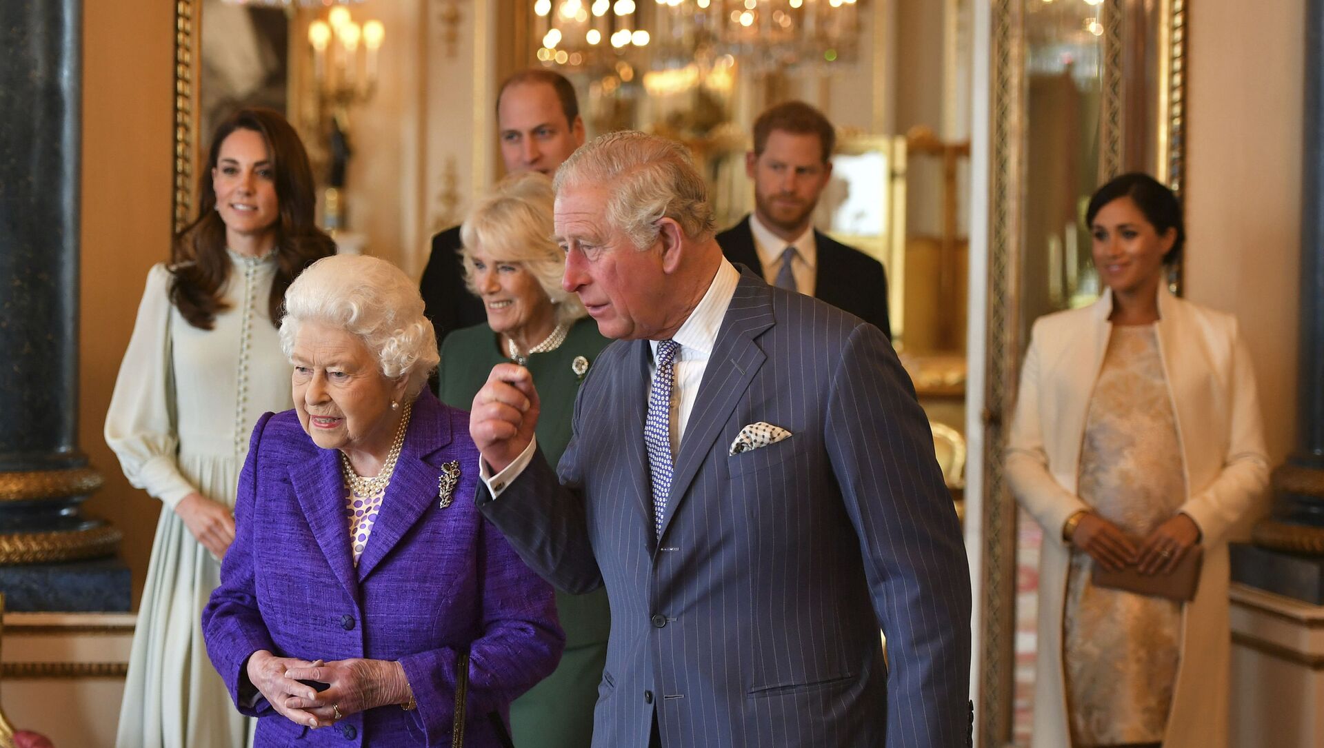 Queen Elizabeth II is joined by Prince Charles, the Prince of Wales, and at rear, from left, Kate, Duchess of Cambridge, Camilla, Duchess of Cornwall, Prince William, Prince Harry and Meghan, Duchess of Sussex during a reception at Buckingham Palace, London, Tuesday 5 March 2019, to mark the 50th anniversary of the investiture of the Prince of Wales. - Sputnik International, 1920, 22.02.2021