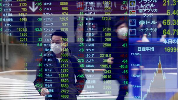 Passersby wearing protective face masks following an outbreak of the coronavirus disease (COVID-19) are reflected on a screen displaying stock prices outside a brokerage in Tokyo, Japan, March 17, 2020 - Sputnik International