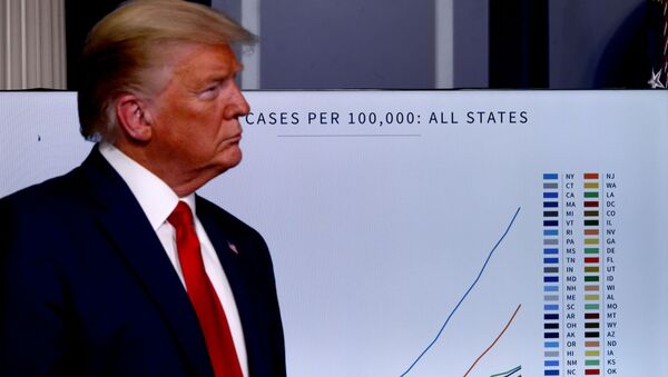 U.S. President Donald Trump stands in front of a chart tracking coronavirus cases in the United States as he faces the daily coronavirus response briefing at the White House in Washington, U.S., March 31, 2020.  - Sputnik International