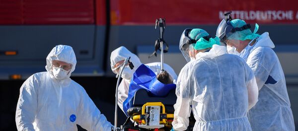 A coronavirus disease (COVID-19) infected patient from France is transferred from an ambulance aircraft to an ambulance car at the airport in Dresden, as the spread of the coronavirus disease (COVID-19) continues in Dresden, Germany April 2, 2020. A coronavirus disease (COVID-19) infected patient from France is transferred from an ambulance aircraft to an ambulance car at the airport in Dresden, as the spread of the coronavirus disease (COVID-19) continues in Dresden, Germany April 2, 2020. - Sputnik International