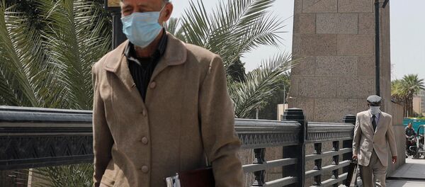 Older men wearing protective masks amid concerns over the coronavirus disease (COVID-19) walk on the Qasr el-Nil Bridge across the Nile river in Egyptian capital Cairo, Egypt March 31, 2020.  - Sputnik International