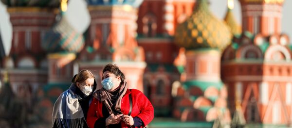 Women with protective masks, widely used as a preventive measure against coronavirus disease (COVID-19), walk across Red Square near the St. Basil's Cathedral in central Moscow, Russia March 26, 2020 Women with protective masks, widely used as a preventive measure against coronavirus disease (COVID-19), walk across Red Square near the St. Basil's Cathedral in central Moscow, Russia March 26, 2020 - Sputnik International